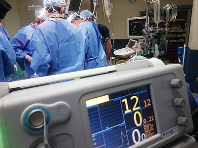 doctors operating near white digital screen device inside building thumbnail