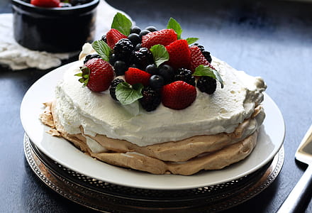 pastry with cream, strawberries, blackberries and blueberries on top thumbnail