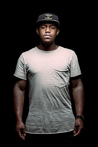man wearing white shirt and black cap thumbnail