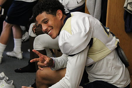 Man in White Jersey Doing Peace Hand Sign thumbnail