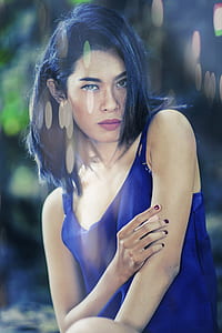bokeh photography of woman in blue sleeveless top thumbnail
