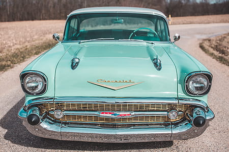 closeup photo of teal Chevrolet Bel Air on road during daytime thumbnail
