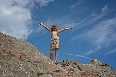 girl spread her arms on top of hill thumbnail