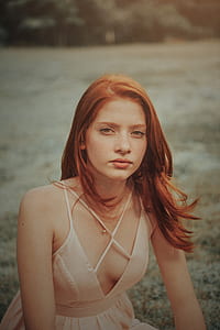 woman sitting on green grass field thumbnail