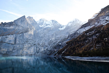 landscape photography of mountain and body of water during daytime thumbnail
