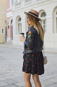 woman wearing black leather jacket and black with cherry print mini skirt thumbnail