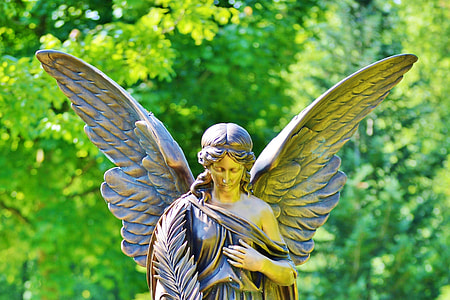 gold-colored female angle statue outdoors thumbnail