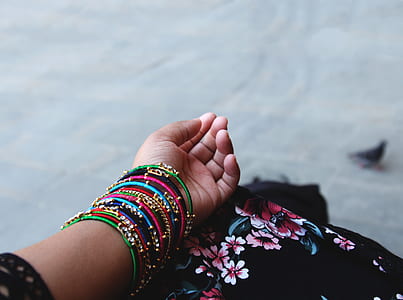 person wearing multicolored chura bangles on person's left arm thumbnail