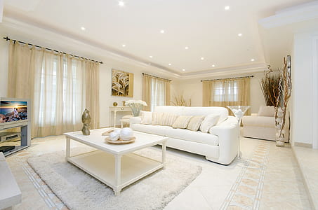 white sofa on floor in front of white coffee table thumbnail