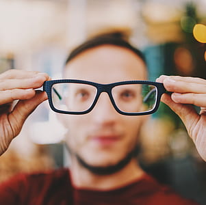 selective focus photograph of black eyeglasses of man thumbnail