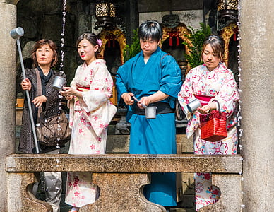 man and three women wearing kimonos in temple thumbnail