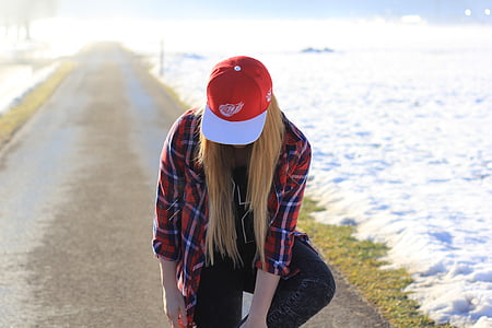woman wearing white and red cap thumbnail