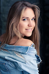 woman wearing blue-washed denim distressed jacket thumbnail