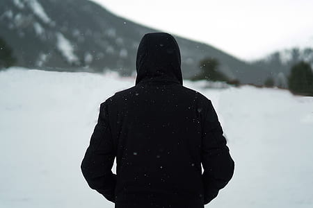 shallow focus photo of man walking on snow field thumbnail