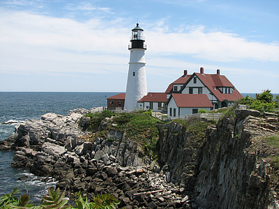 photography of white lighthouse on mountain over body of water thumbnail