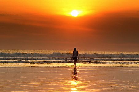 woman walking on the seashore thumbnail