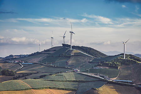 windmill on mountain during daytime thumbnail