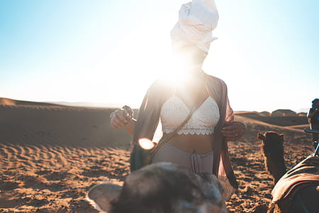 woman wearing white bra standing on sand thumbnail