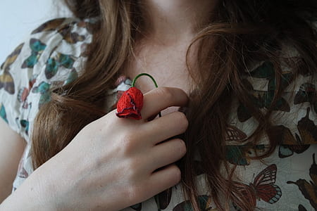 woman in white top holding red rose thumbnail