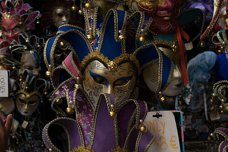 yellow and blue jester mask hanging on wall thumbnail