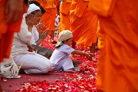 boy sitting on floor covered in red petals thumbnail