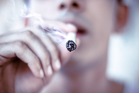 man holding cigarette stick thumbnail
