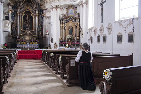woman kneeling her nee on church while prayingh thumbnail