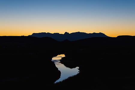 silhouette photo of mountain during sunset thumbnail