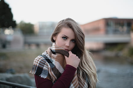 woman wearing marono long-sleeved top and white and brown plaid scarf taking photo during daytime thumbnail