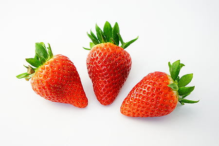 three red strawberries placed on white surface thumbnail
