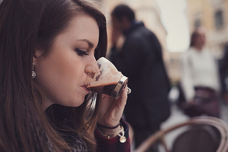 Woman drinking coffee in cafe thumbnail