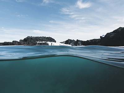 black and gray rock formation on body of water thumbnail