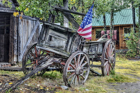 brown wooden wagon with USA flag during daytime thumbnail