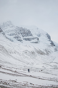 person in gray jacket on beside of snowy mountain during daytime thumbnail
