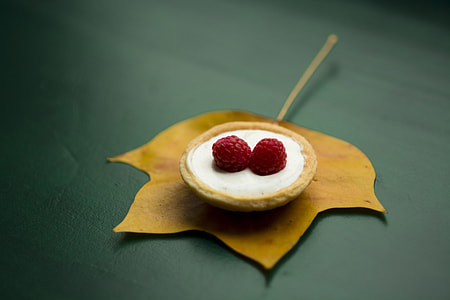 two red raspberries on white surface thumbnail