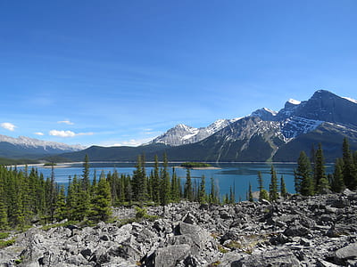 body of water in front of snow covered mountain thumbnail