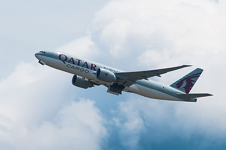 flying white Qatar Cargo plane thumbnail