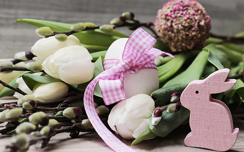 white petaled flowers beside pink rabbit figurine thumbnail