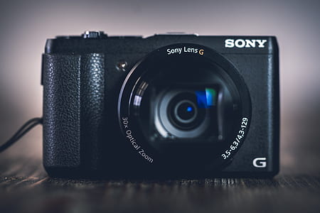 black Sony G-series point-and-shoot camera on gray surface thumbnail