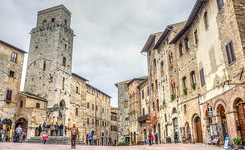 people standing in front stone building at daytime thumbnail