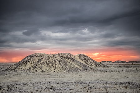 white hill during cloudy sky thumbnail