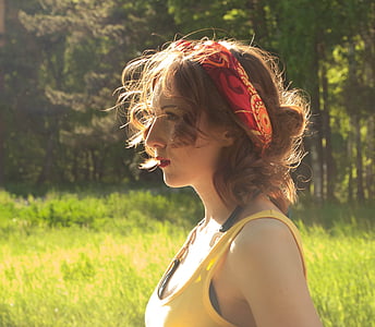 woman in yellow tank top standing on green grass lawn during daytime thumbnail