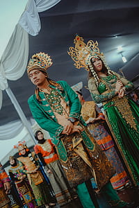 woman and man wearing green carnival attires thumbnail