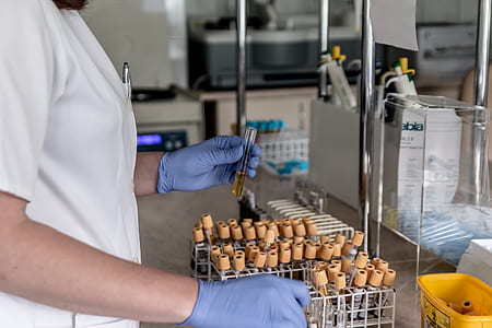 person holding glass vial thumbnail