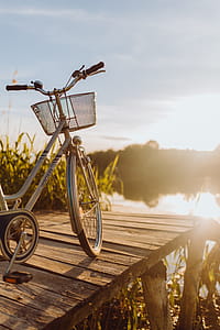 Bicycle with basket on the pier in bright sunset light thumbnail