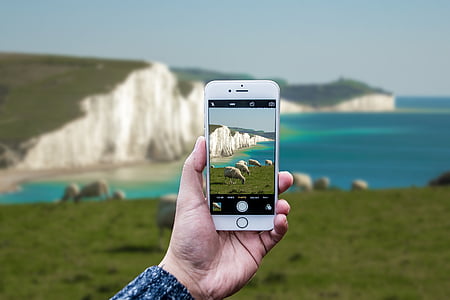 person holding silver iPhone 6 capturing mountain thumbnail