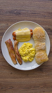 bread, hotdog, scrambled egg, and bacon on plate thumbnail