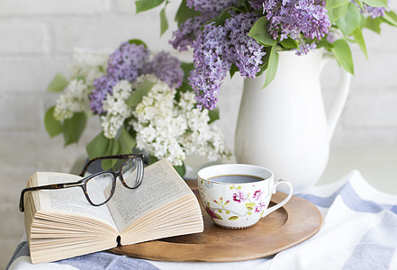 white open book with eyeglasses near teacup thumbnail