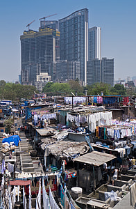 clothes on clothesline on top of houses with building in background thumbnail