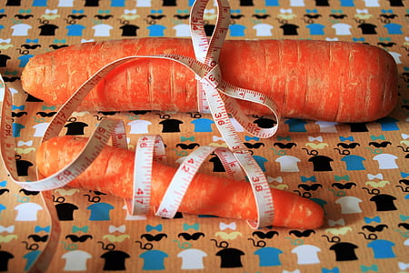 two orange carrots on brown surface thumbnail